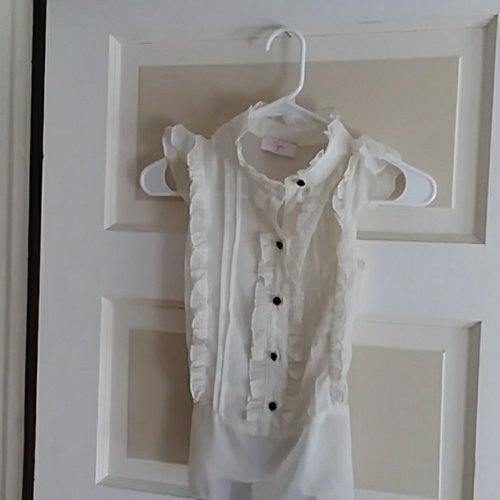 Aqua ivory ruffled blouse with black buttons.